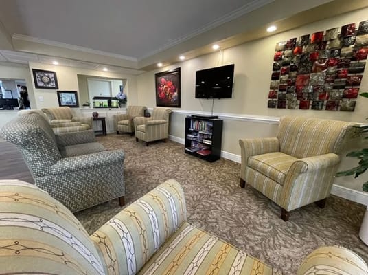 Cozy lounge area with seating and a television.