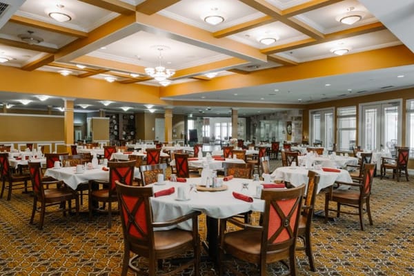 Interior view of a dining room with tables set for meals