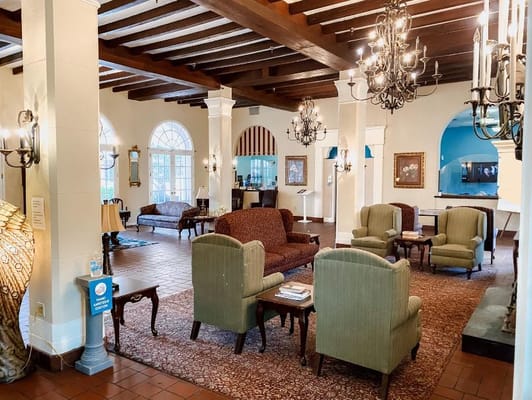Cozy lobby area with seating and chandeliers