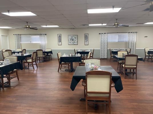 Dining area with tables and chairs set for meals