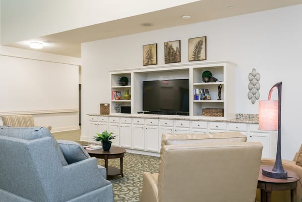 View of a cozy living room with seating and a television.
