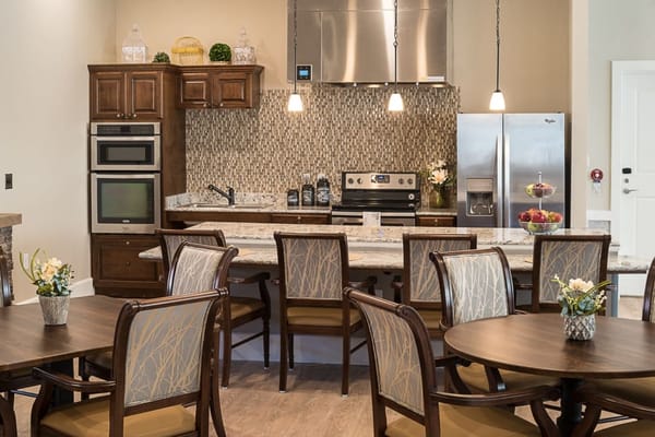 Modern kitchen area with dining tables and seating
