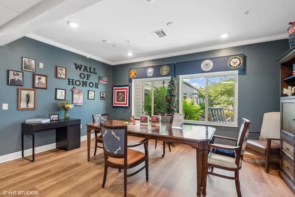 Meeting room featuring a Wall of Honor with photographs and military emblems.