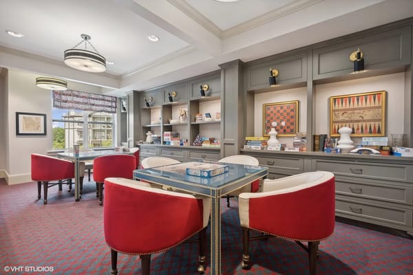 Cozy game room with red chairs and shelves of board games
