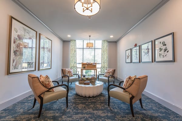 Cozy lounge area with seating and decorative art at The Phoenix at Hammond.
