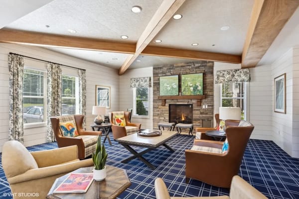 A cozy living room featuring comfortable seating and a fireplace.