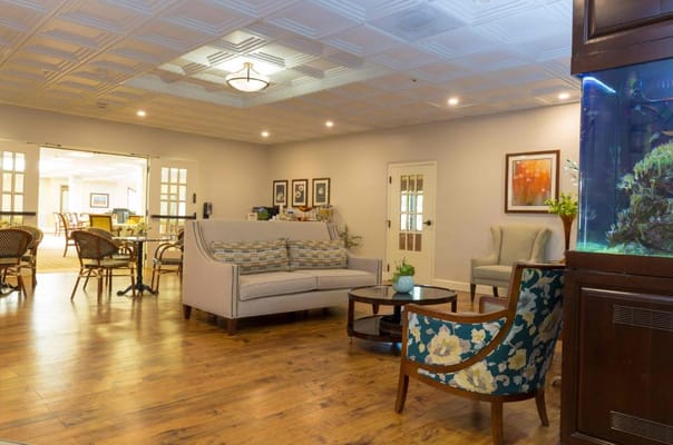 Cozy lounge area with seating and aquarium