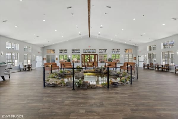 Bright and spacious lobby featuring a water feature and seating area
