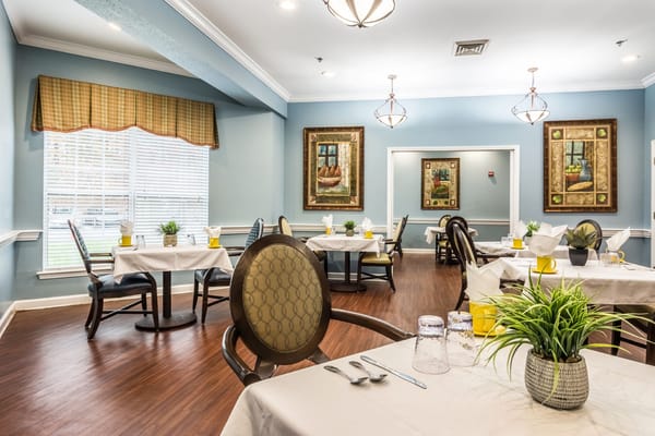 Cozy dining room with tables set for meals
