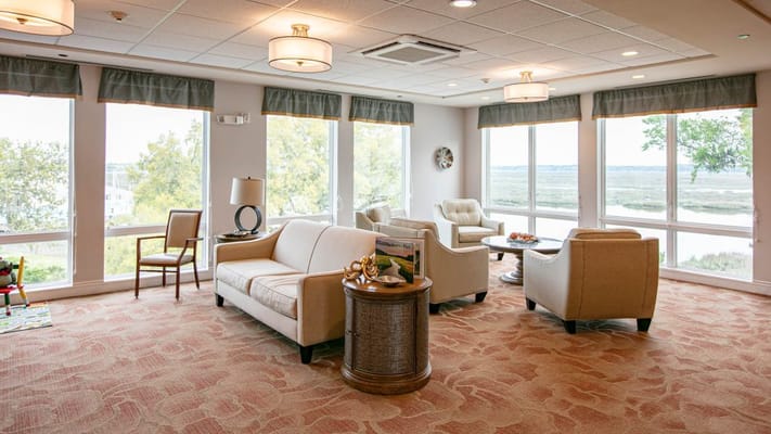 Bright common area with seating and large windows