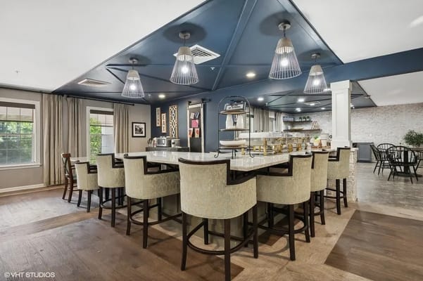 Spacious dining area with bar seating and modern lighting