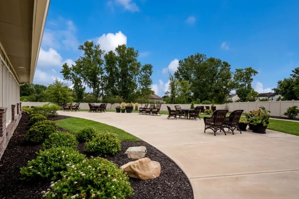 A spacious patio area with seating and greenery at The Ridge at Beavercreek