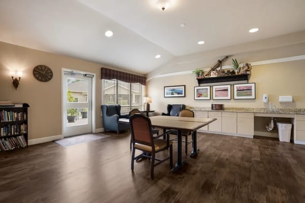 Bright and spacious common area with seating and a bookshelf
