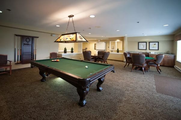 Activity room with a pool table and seating