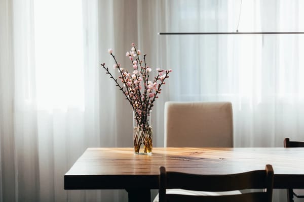 Floral arrangement on a dining table with soft natural light