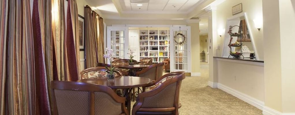 Cozy common area featuring tables and chairs with floral decor