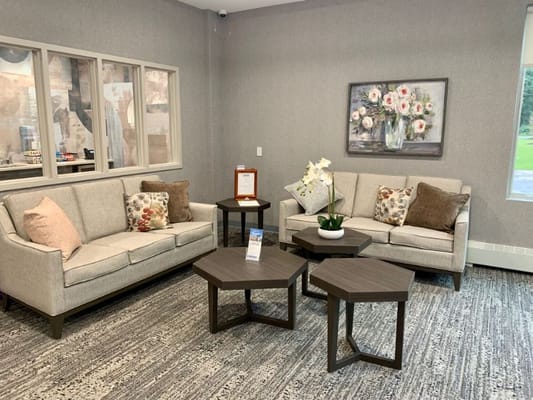 Comfortable living room seating area with decorative floral artwork