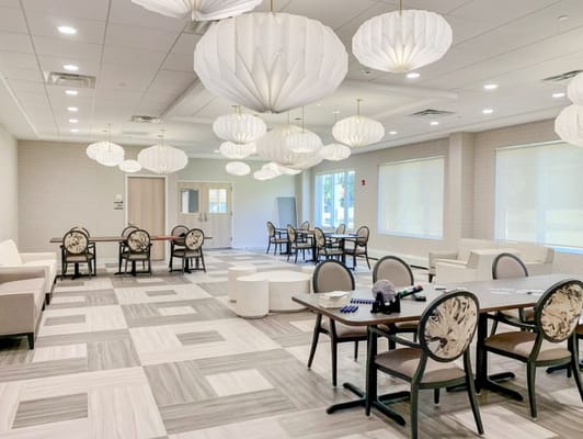 Bright and modern common area with seating and dining tables