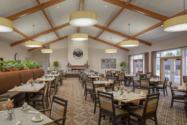 Bright dining room with tables set for meals