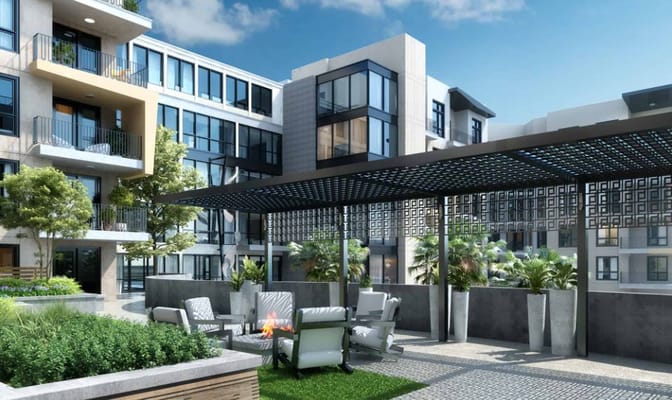 Outdoor lounge area with seating and greenery