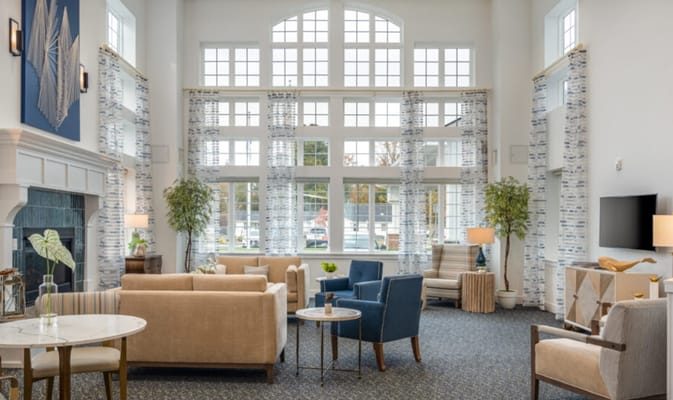 Bright and spacious living room with comfortable seating and large windows