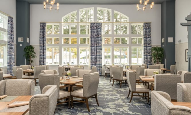 Spacious dining area with large windows and tables at The Vero at Chesapeake.