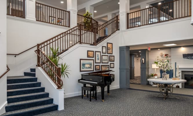 Lobby featuring a grand piano and staircase