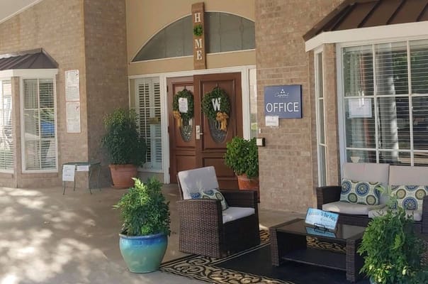 Entrance to the office area with seating and decorative plants.