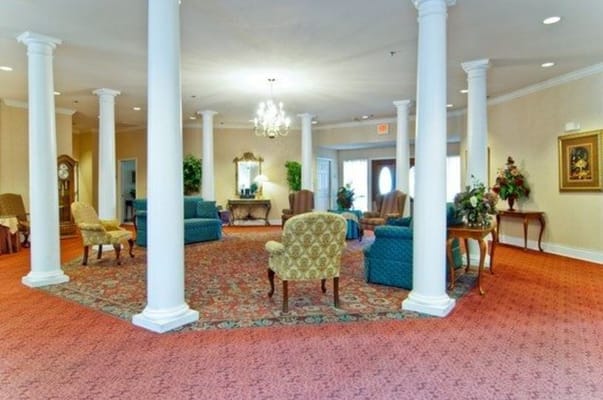 Cozy lobby with seating and decorative pillars.