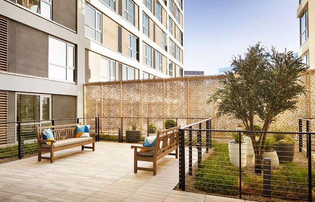 Outdoor patio with seating and greenery at The Watermark at Westwood Village.
