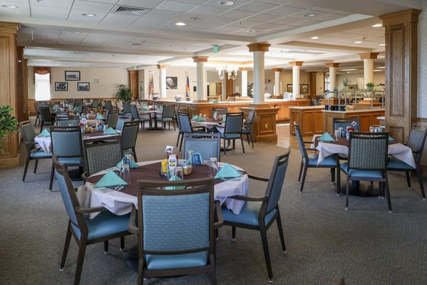Bright dining room with tables set for meals