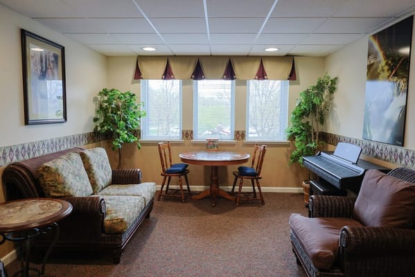 Lounge with comfortable seating and a round table in a well-lit room