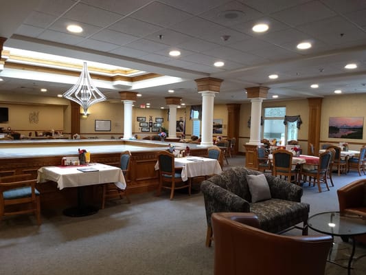 Dining area with tables and chairs in a senior living facility