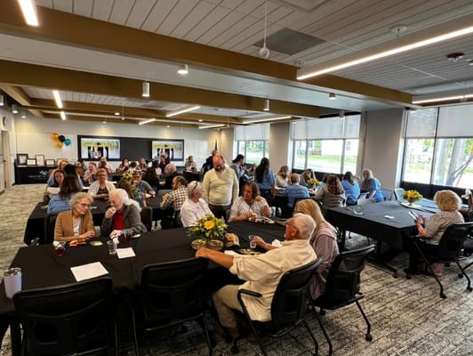 Residents and staff enjoying an event in the common area.