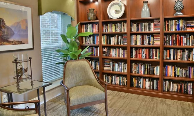 Inviting library space with bookshelves and comfortable seating.
