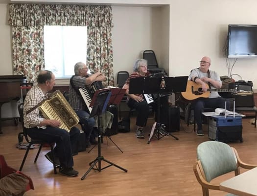 Residents playing musical instruments in a common area