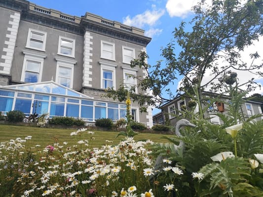 Exterior view of the facility with flowers in foreground