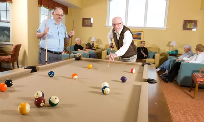 Residents playing pool in a common area
