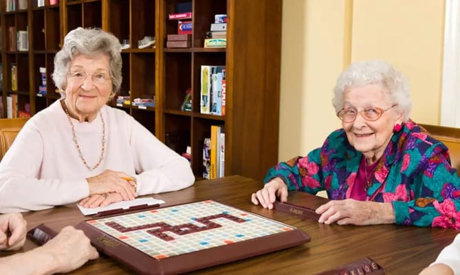 Two residents enjoying a game of Scrabble in a common area