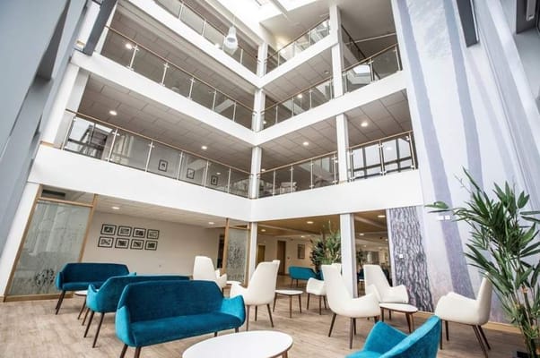 Modern lobby area with seating and greenery
