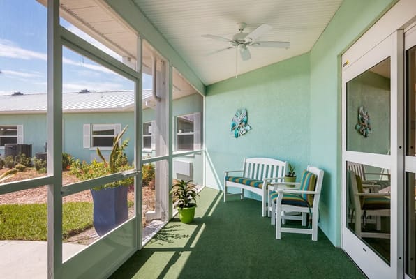 Porch with seating and greenery in Trinity Place Assisted Living
