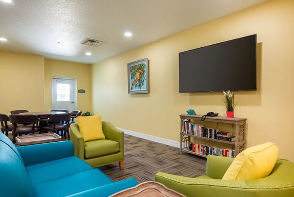 Comfortable seating area with colorful chairs and a TV
