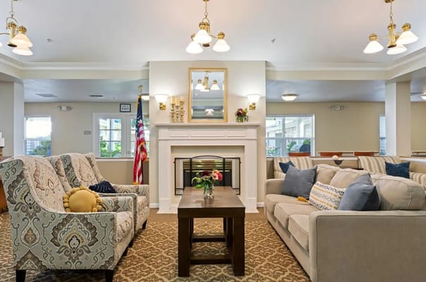 Inviting living room with seating, decorative lights, and a fireplace