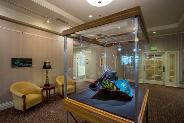 Colorful art piece showcased in a glass display case.