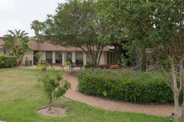 Well-maintained garden and pathway outside the facility