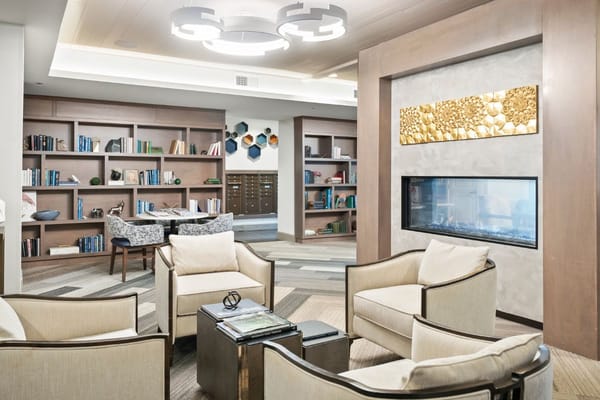 Comfortable seating area with bookshelves and a fireplace