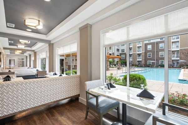 A dining area overlooking a pool at Verena at Bedford Falls