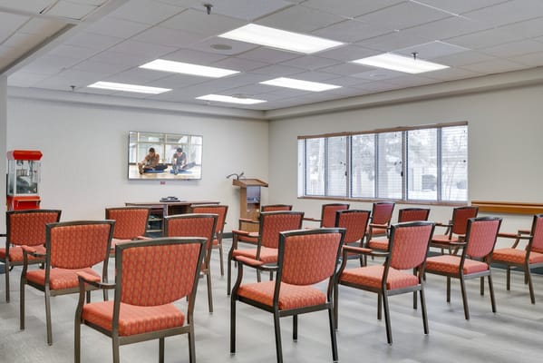 Common area with empty chairs and a small stage