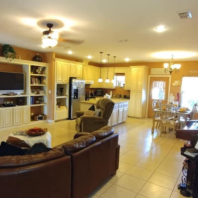 Open kitchen and living area with comfortable seating at Victoria Comfort Homes.