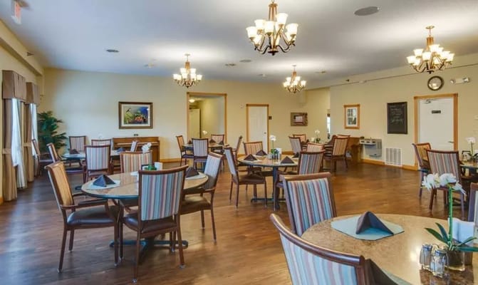 Spacious dining room with tables and chairs in a senior living facility